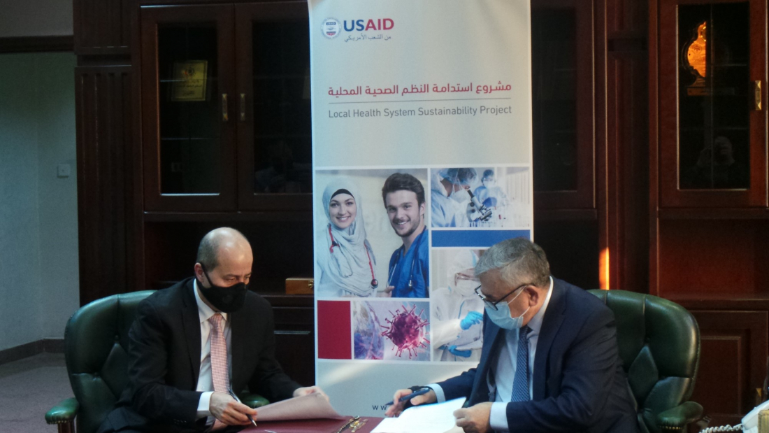 Nurses and Midwives Council President Khaled Rababa’h, left, and Minister of Health Nathir Obeidat at the Call Center signing ceremony on Jan. 7, 2021.