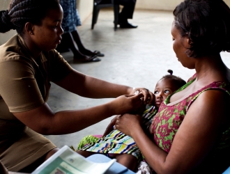 A nurse vaccinates a child at a clinic in Accra, Ghana. 
