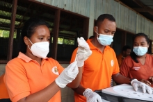 People preparing COVID-19 vaccines in Timor-Leste