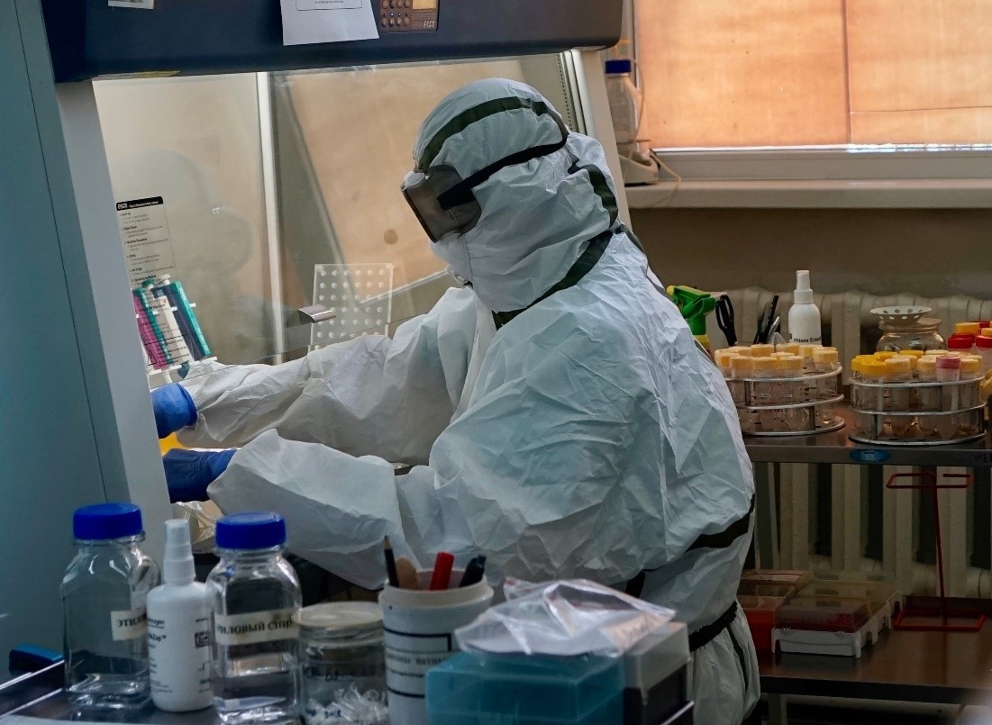 A laboratory specialist in Kazakhstan handles samples for testing in July 2020. 
